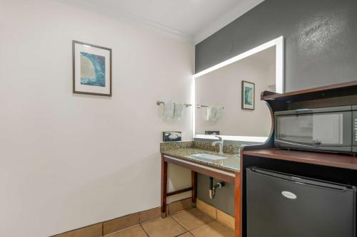 a bathroom with a sink and a microwave at Best Western Park Crest Inn in Monterey