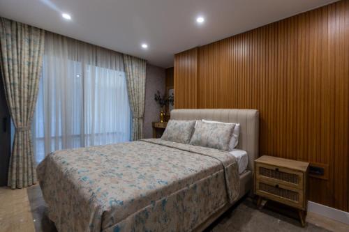 a bedroom with a large bed and a window at Marje Villas Bodrum in Bodrum City