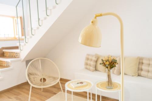 a white living room with a table and a lamp at El Granerillo de Cazalla in Cazalla de la Sierra