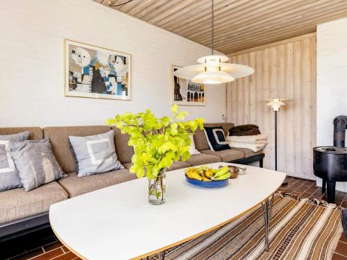 a living room with a table and a couch at 6 person holiday home in Pandrup in Rødhus