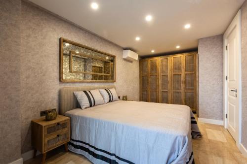 a bedroom with a bed and a picture on the wall at Marje Villas Bodrum in Bodrum City