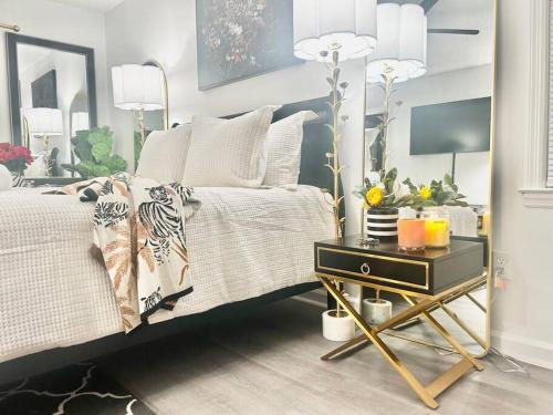 a bedroom with a bed and a table with a night stand at 5BR Southern Dream Home in Columbia