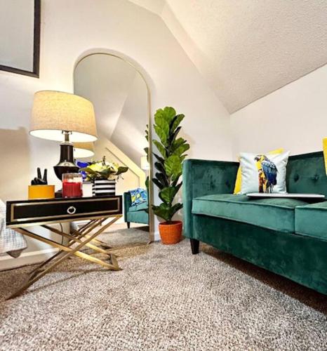 a living room with a green couch and a table at 5BR Southern Dream Home in Columbia