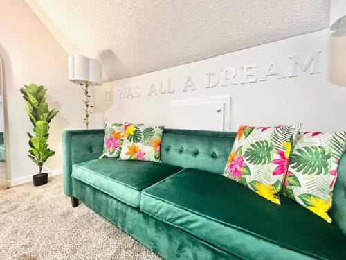 a green couch with pillows in a living room at 5BR Southern Dream Home in Columbia