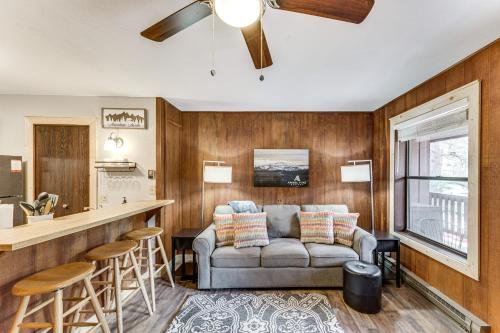 a living room with a couch and a bar at Rustic Angel Fire Condo Resort Shuttle On-Site! in Angel Fire