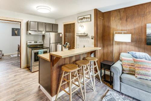 a kitchen with a bar with stools and a couch at Rustic Angel Fire Condo Resort Shuttle On-Site! in Angel Fire