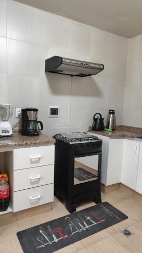 a kitchen with a black stove top oven at Departamento céntrico y amoblado La Paz in La Paz