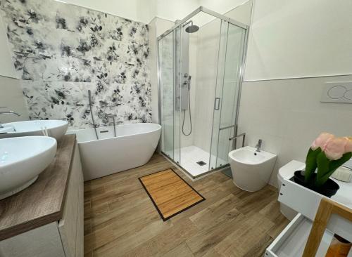 a bathroom with two sinks and a tub and a shower at Casa Belfiore Etna-apartments in Giarre