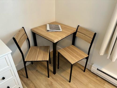 a small table with two chairs and a book on it at San Dune Inn in Manzanita