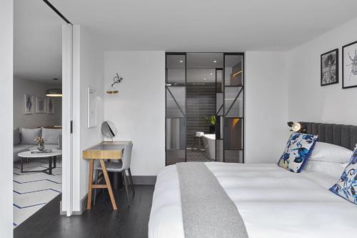 a bedroom with a bed and a desk in a room at Kimpton De Witt Amsterdam by IHG in Amsterdam