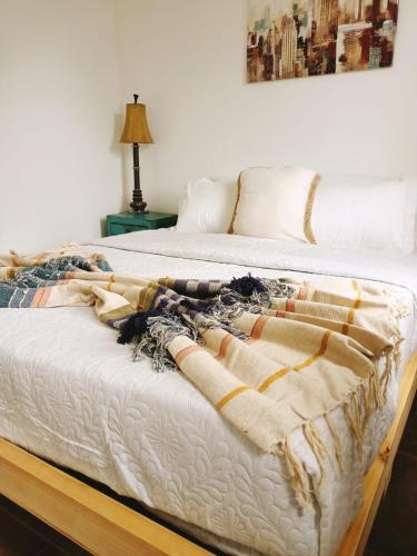 a bed with a blanket on top of it at Cabañas Toto Península Beach in Totoralillo