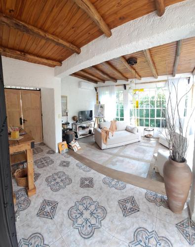 a living room with a couch and a table at CASA ADAGIO in Ciudad Lujan de Cuyo