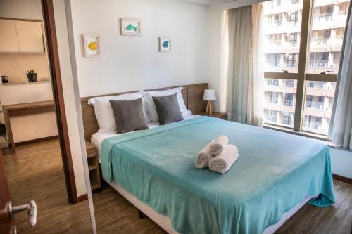 Ένα ή περισσότερα κρεβάτια σε δωμάτιο στο Rio Centro Stay