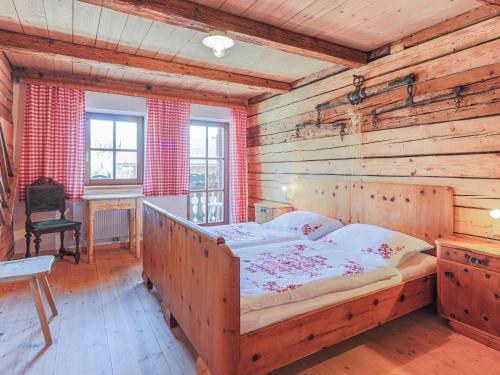 a bedroom with a bed in a wooden room at Hauserbauer Small in Bramberg am Wildkogel