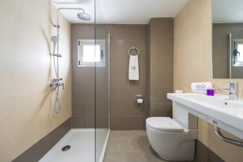 a bathroom with a shower and a toilet and a sink at eó Corona Cedral in Puerto Rico de Gran Canaria