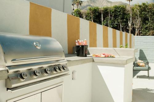 a kitchen with a grill and a plate of food at Mod Hotel in Palm Springs