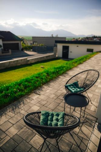two chairs and a table on a patio at Apartmány Na Vŕšku in Kežmarok