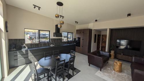 a kitchen and living room with a table and chairs at Black Beach Apartment - Vík in Vík
