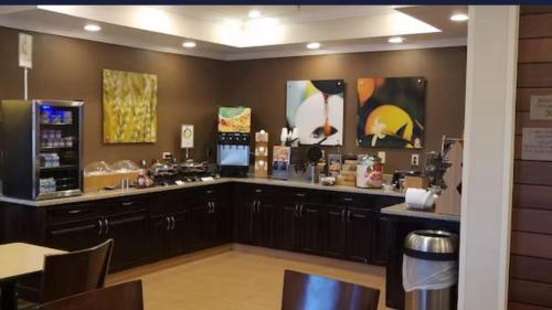 a kitchen with a counter and a bar in a restaurant at AmericInn by Wyndham Moline Airport/Quad Cities in Moline
