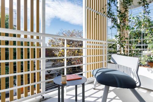 a balcony with two chairs and a window at Bromelia Hotel Boutique in Buenos Aires