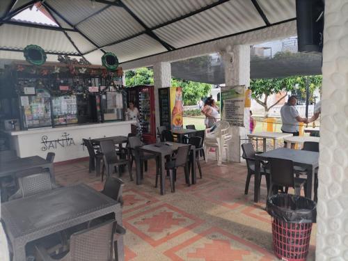 a restaurant with tables and chairs and people sitting at tables at CASA VACACIONAL SAMARIA in Flandes