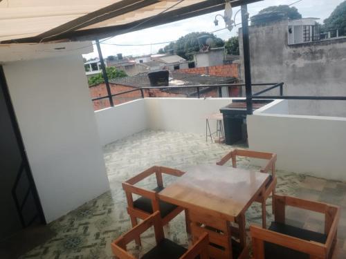 a room with a table and chairs on a balcony at CASA VACACIONAL SAMARIA in Flandes