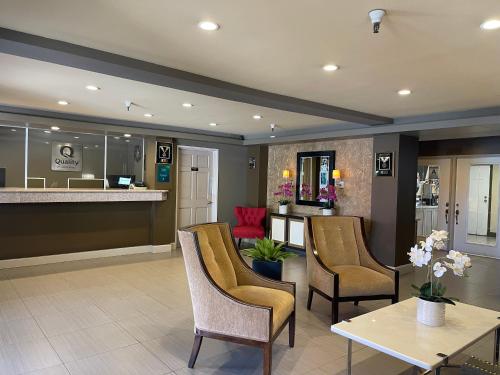 a lobby with chairs and a table and a bar at Quality Inn Ontario Airport Convention Center in Ontario