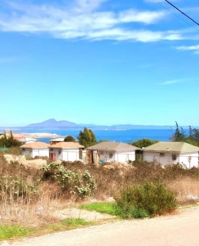 a row of houses on top of a hill at Cabañas Toto Península Beach in Totoralillo