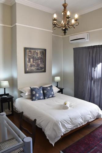 a bedroom with a bed with a stuffed animal on it at Poetry Guestrooms in Vryburg