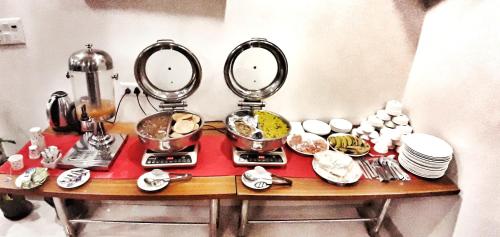 a table with three mirrors and dishes on it at Airport Hotel Delhi Aerocity in New Delhi