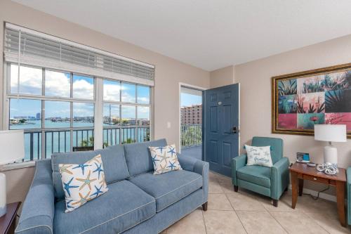 a living room with a blue couch and a chair at 406 Dockside in Clearwater Beach