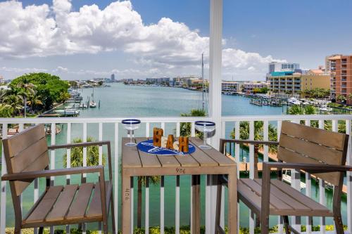 a table and chairs on a balcony with a view of the water at 406 Dockside in Clearwater Beach