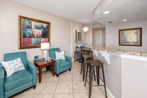 a living room with two chairs and a bar at 406 Dockside in Clearwater Beach