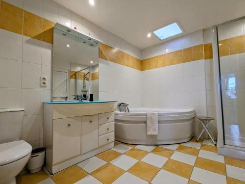y baño con bañera, aseo y lavamanos. en Guestroom Châteauroux, 1 pièce, 4 personnes - FR-1-591-388, en Châteauroux