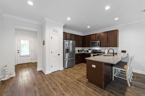 a kitchen with wooden cabinets and a counter top at Sound Haven Coastal Escape in Navarre