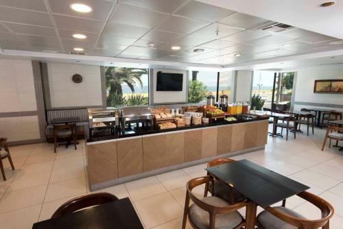 a restaurant with a buffet with tables and chairs at Holiday Inn Express - Antofagasta by IHG in Antofagasta
