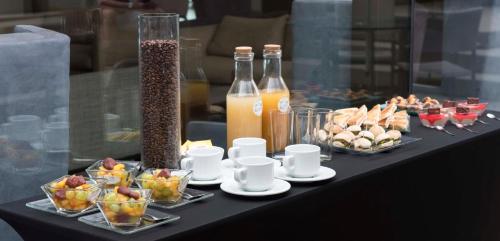 a table with plates of food and bottles of drinks at Holiday Inn Express - Antofagasta by IHG in Antofagasta