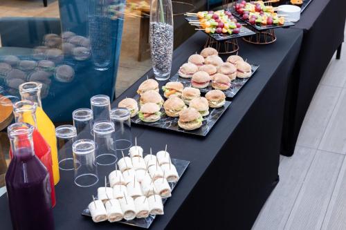 a black table with plates of food and drinks at Holiday Inn Express - Antofagasta by IHG in Antofagasta