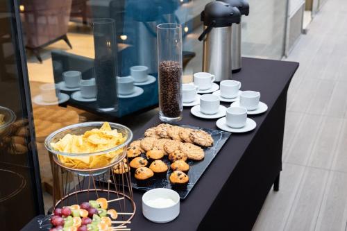 a black table with cookies and chips and other food at Holiday Inn Express - Antofagasta by IHG in Antofagasta