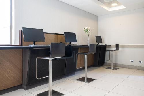 a conference room with three desks with computers on them at Holiday Inn Express - Antofagasta by IHG in Antofagasta