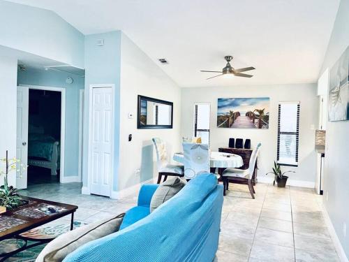 a living room with a blue couch and a table at Heated Pool home fenced yard near the beach in Palm Coast