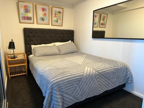 a bedroom with a bed and a mirror on the wall at The Retreat Adelaide in Adelaide