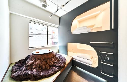 a small room with a tree stump bed in it at Cocts Akihabara in Tokyo