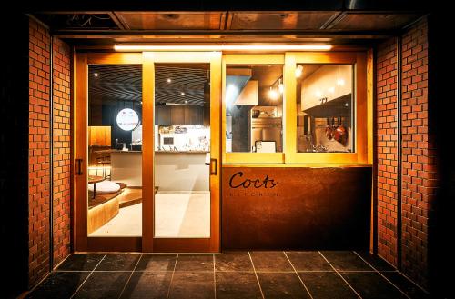 a door to a store with a cork sign on it at Cocts Akihabara in Tokyo