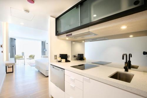 a kitchen with a sink and a counter top at Miss Baker's Boutique Accommodation Bondi in Sydney