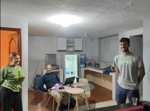 a group of three men standing in a kitchen at Tiki Hostel in Riobamba
