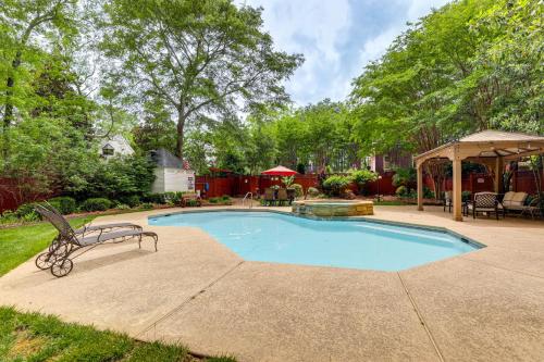 a swimming pool in a backyard with a table and chairs at Buford Mansion with Pool about 14 Mi to Lake Lanier in Buford