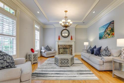 a living room with two couches and a fireplace at Buford Mansion with Pool about 14 Mi to Lake Lanier in Buford