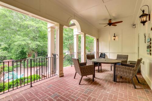 a screened in porch with a table and chairs at Buford Mansion with Pool about 14 Mi to Lake Lanier in Buford