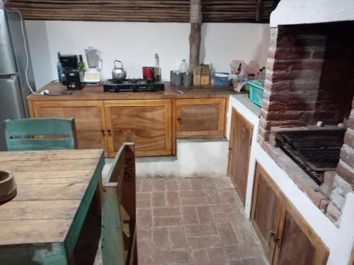 a kitchen with wooden cabinets and a counter top at El Puente in El Paredón Buena Vista